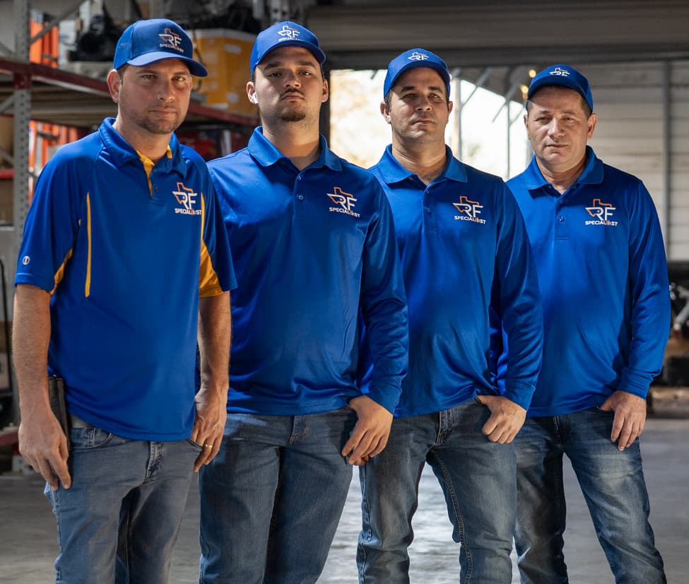Four RF Specialist team members in branded blue uniforms